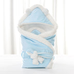 Newborn baby being hugged and swaddled by baby